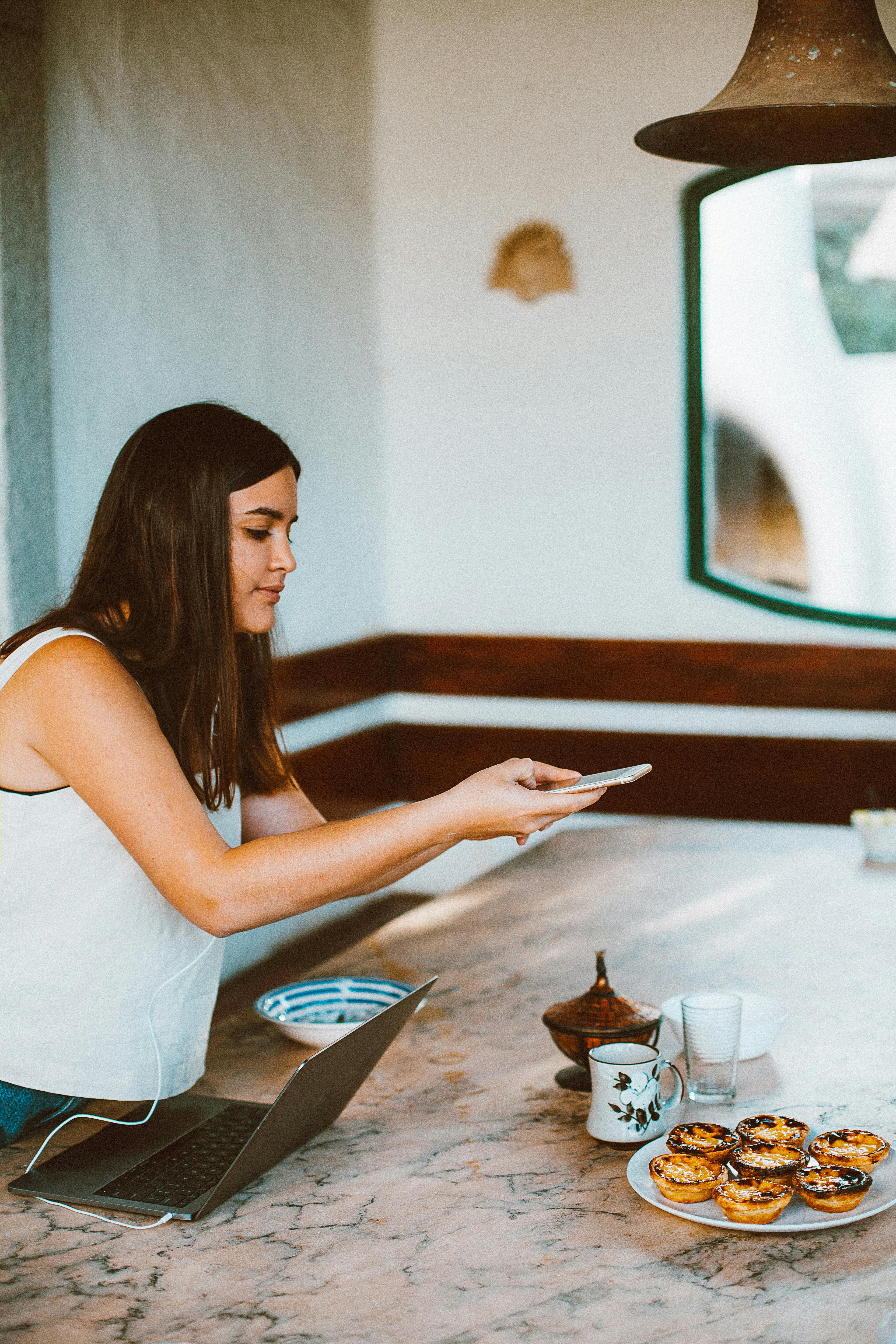 Woman Using Smartphone Taking a Picture of Food