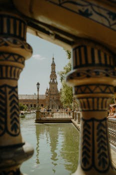 Artistic perspective of Plaza de España's architecture through ceramic balustrades on a sunny day.