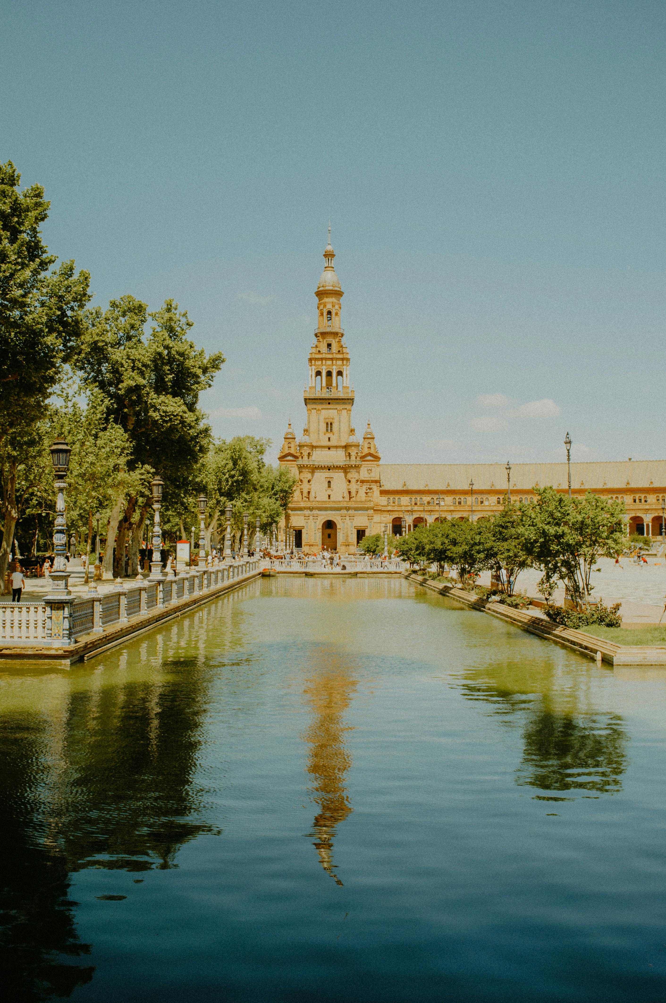clear sky over pond and tower at plaza de espana