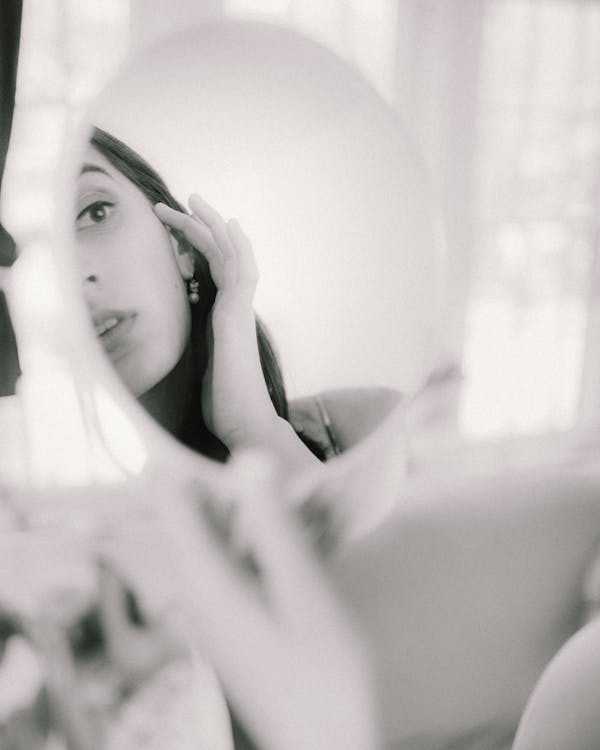 Free Beautiful Woman Looking at Reflection in Mirror Stock Photo