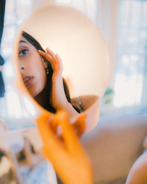 Young Brunette Looking in Mirror