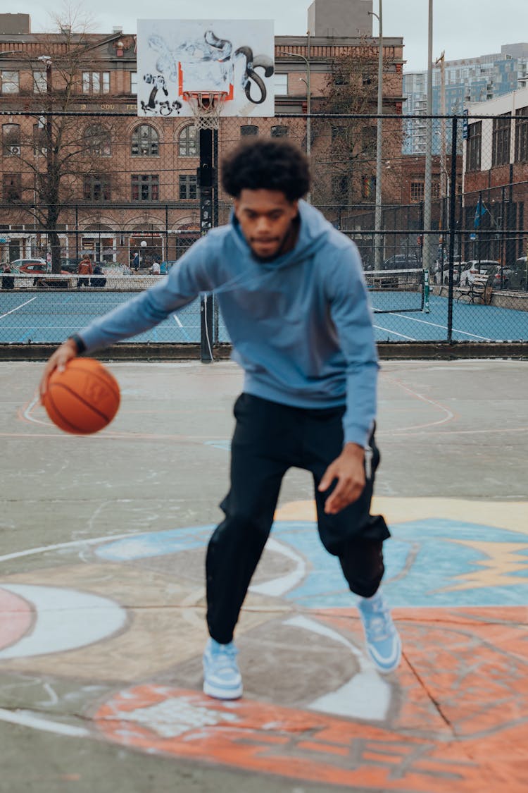 Black Man Playing Basketball On Outdoor Court