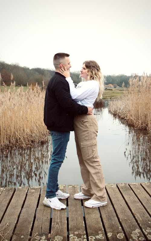 A Couple Standing on a Wooden Jetty 