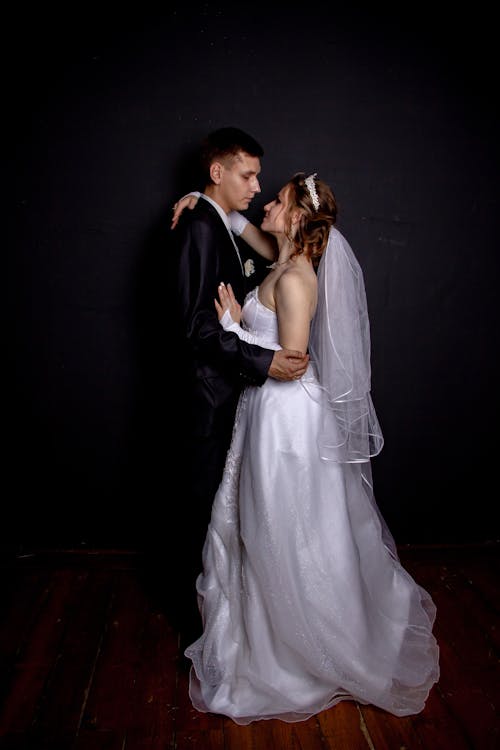 Newlyweds Hugging on Black Background