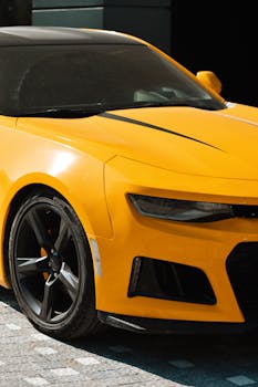 Sleek yellow sports car under daylight on a city street in Manavgat, Türkiye.