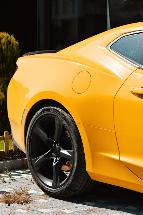 Back Part of a Yellow Chevrolet Camaro on a Parking Lot 