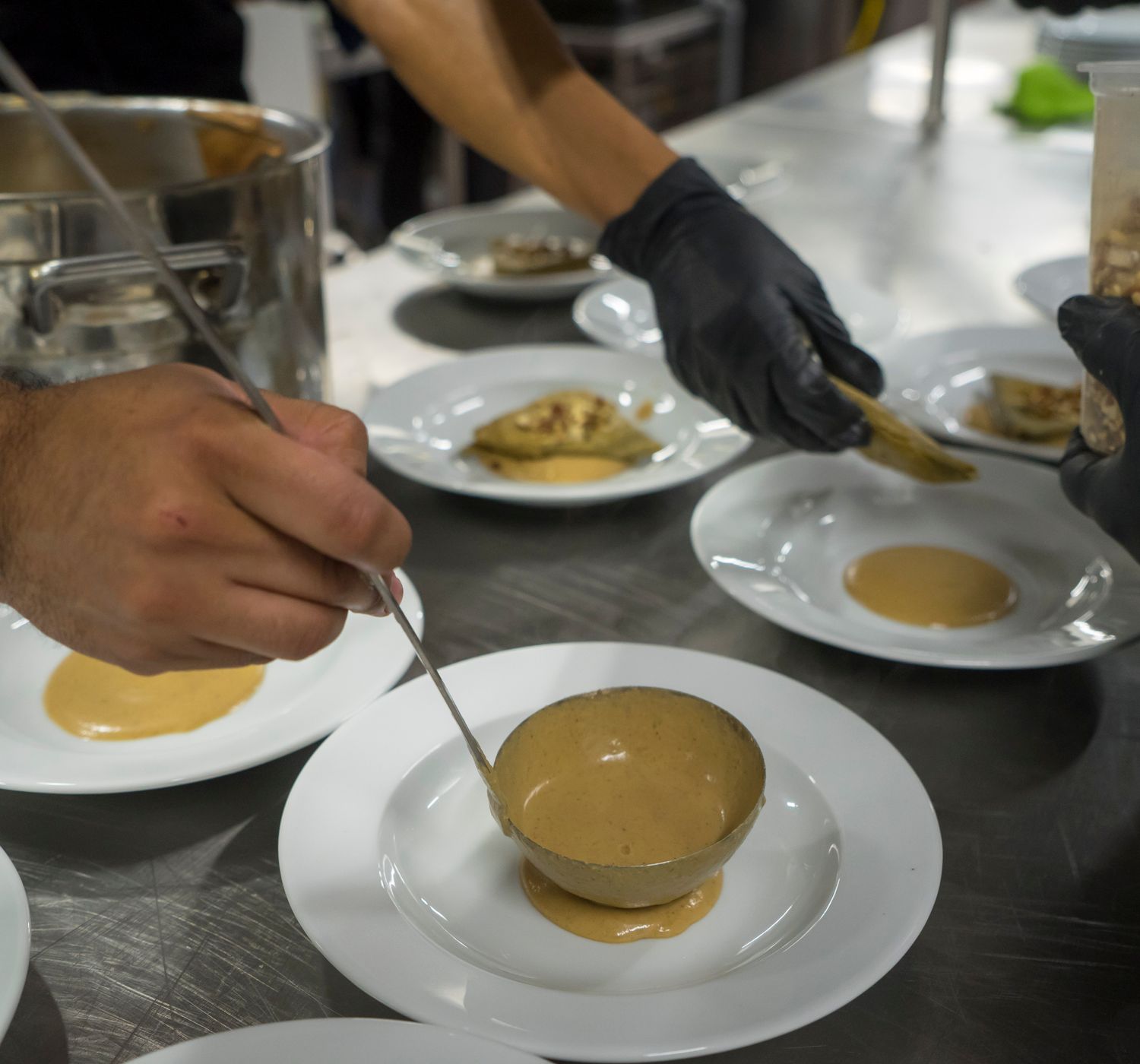 Chefs plating dishes in the Emberline kitchen