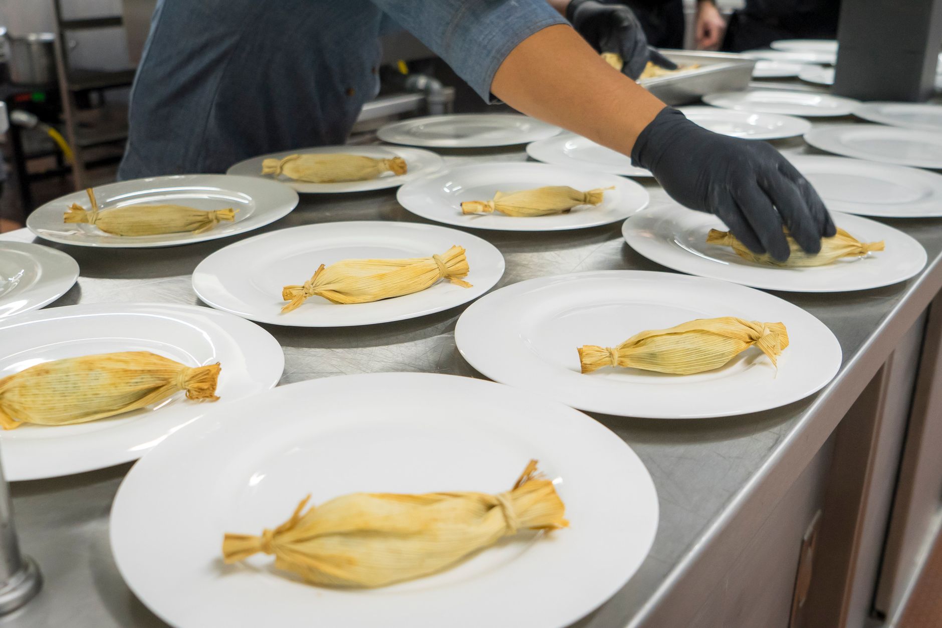 Close-up of steaming tamales wrapped in corn husks in pot