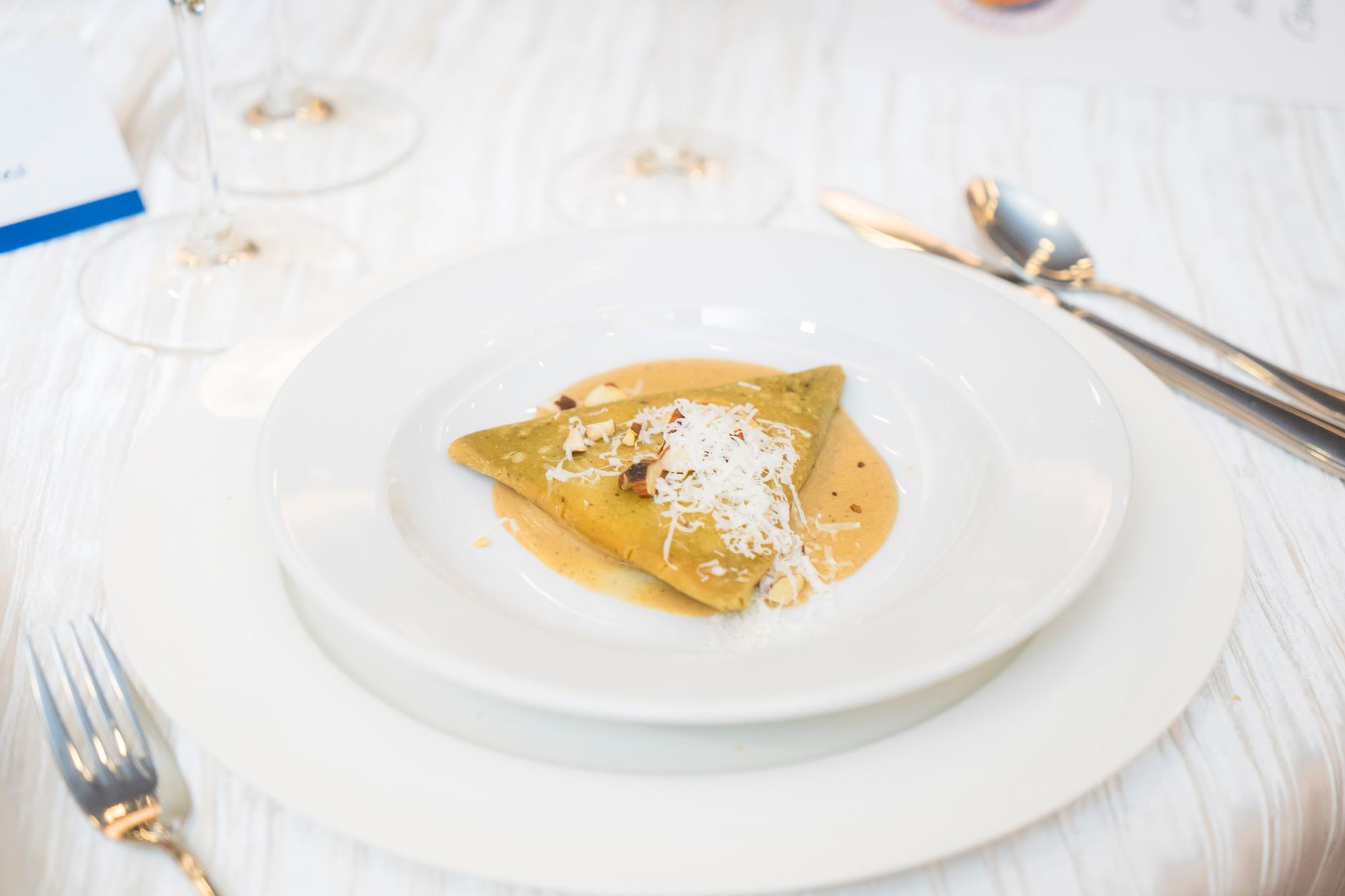 Roasted Butternut Squash Ravioli plated with sage and hazelnut brown butter sauce