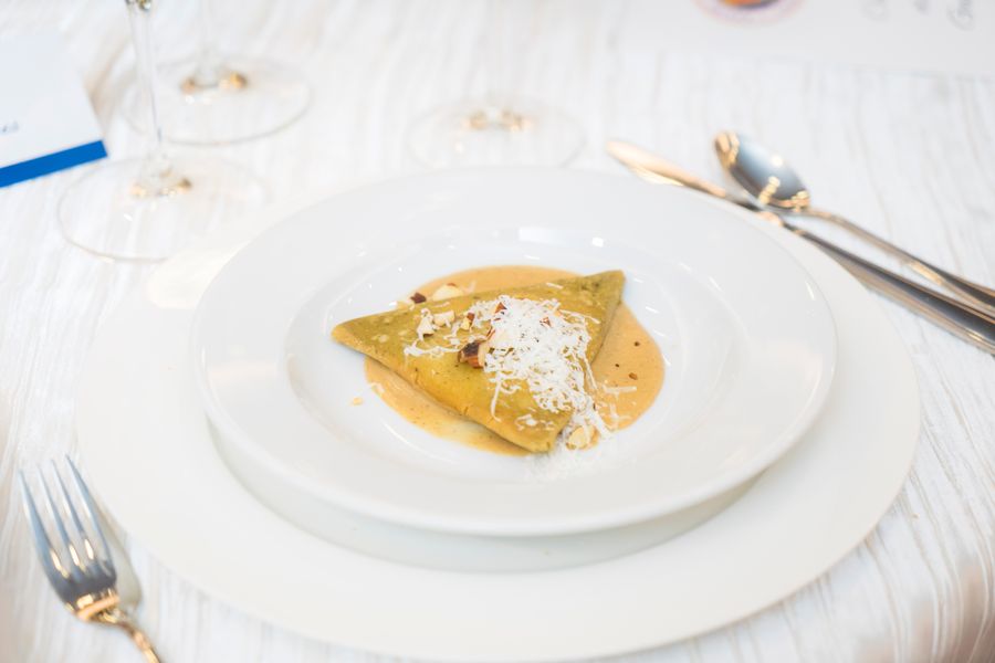 Gourmet dish with cheese garnish