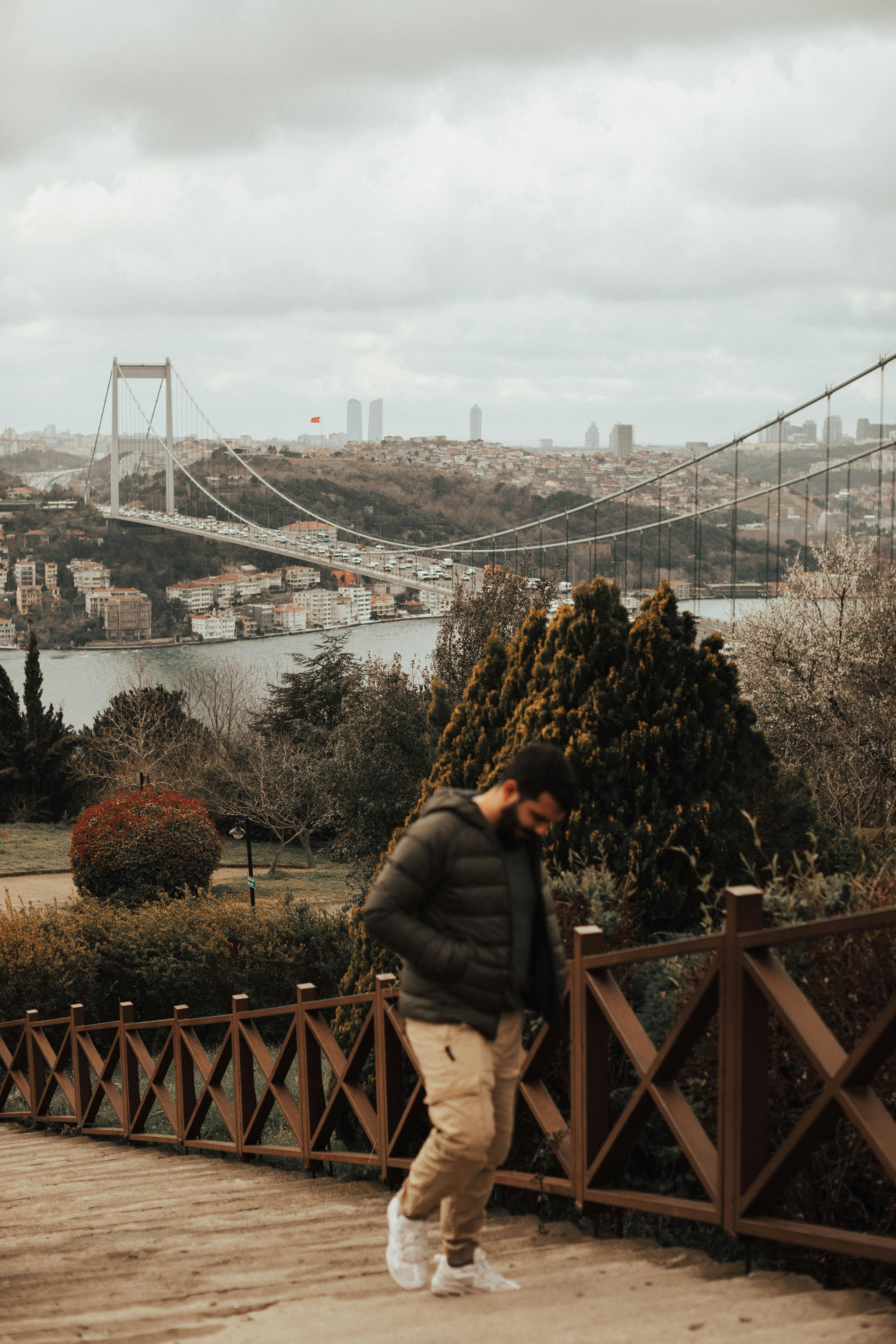 A man walking upstairs near suspension bridge