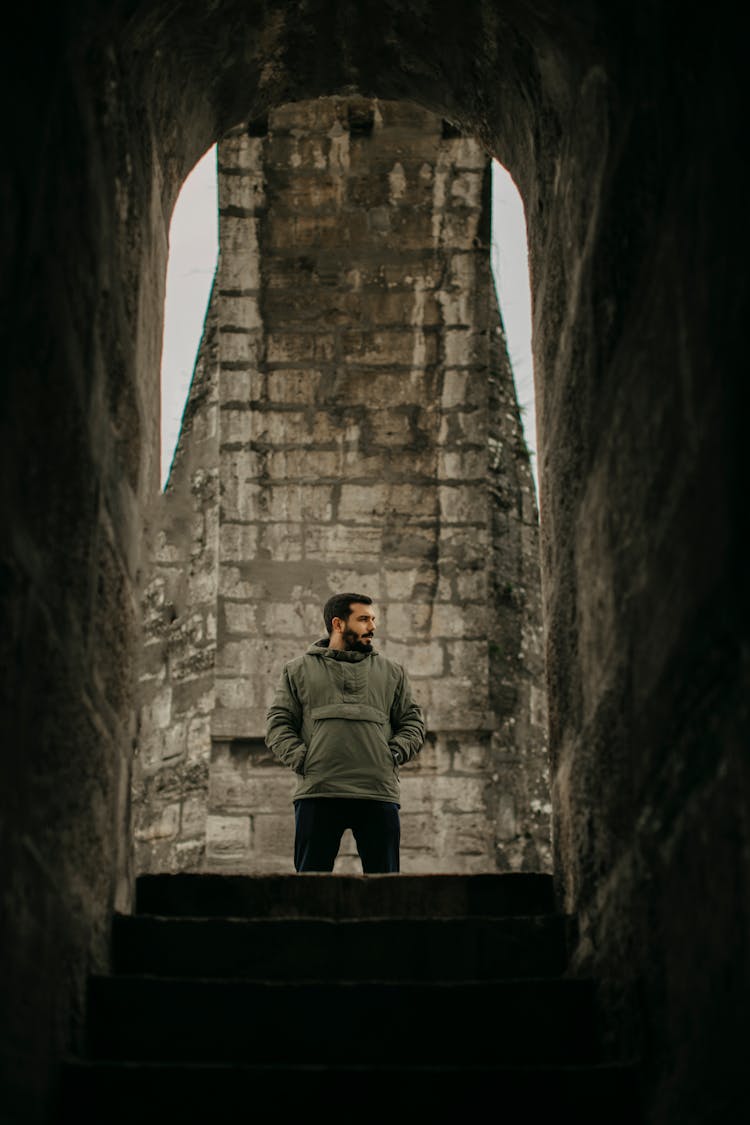 Young Man Standing Near Stone Old Building 