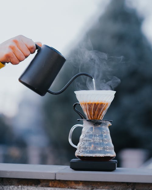 Free Close-up of Person Pouring Hot Water into a Coffee Pot with a Coffee Filter  Stock Photo