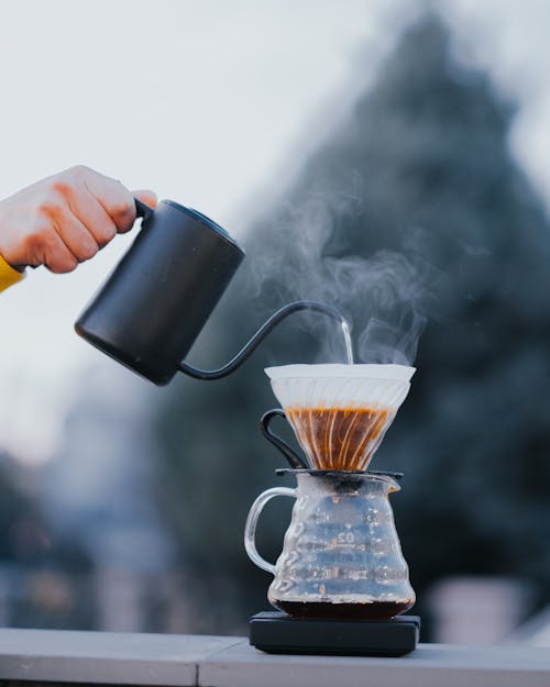 Free Close-up of Person Pouring Hot Water into a Coffee Pot with a Coffee Filter  Stock Photo