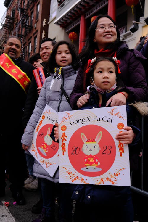 Family with Banners in the Crowd of Onlookers at the Festival