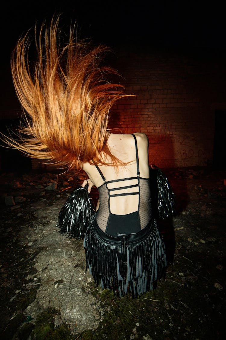 Redhead Woman Waving Hair In Dark