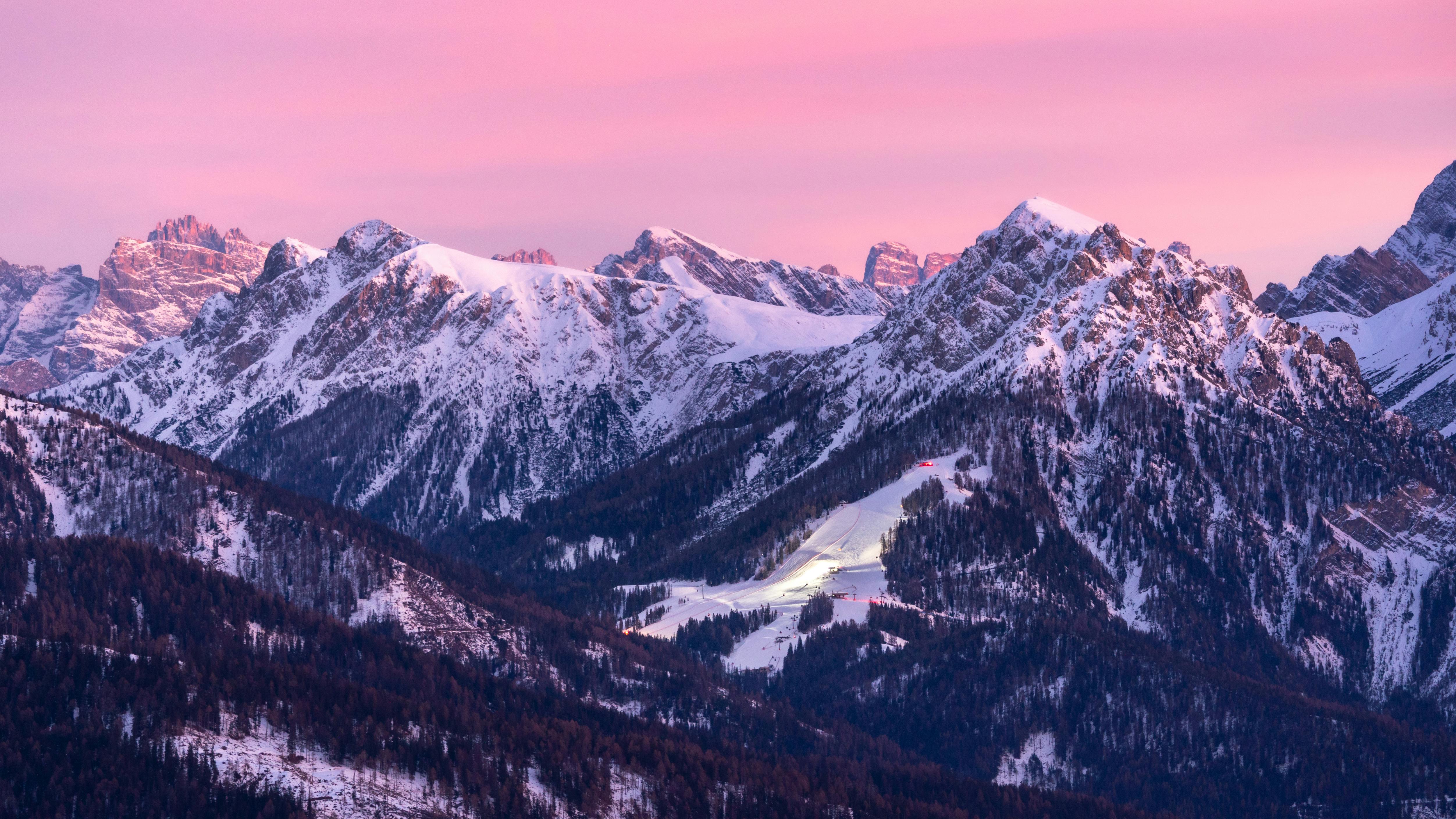 Prescription Goggle Inserts - Stunning panoramic view of snow-covered Alps during sunset, showcasing serene winter beauty.