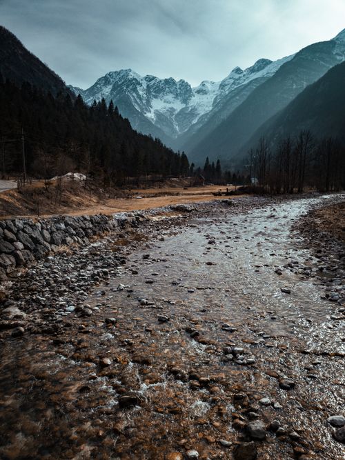 Free Scenic view of snowcapped mountains and a river in Soča, Slovenia during winter. Stock Photo