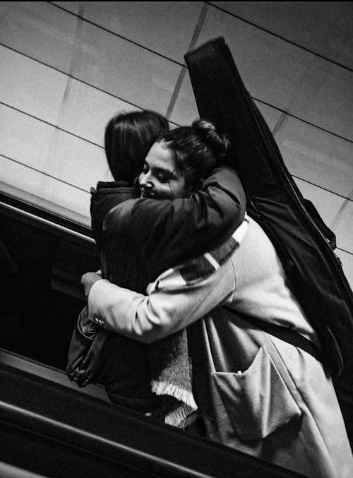 People on an Escalator Hugging 