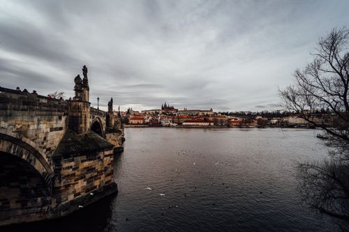 Free Stunning view of Charles Bridge and Prague Castle over the Vltava River on a cloudy day. Stock Photo