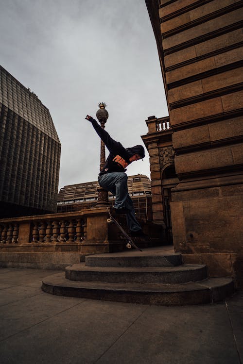 Boy Jumping on a Skateboard in City 