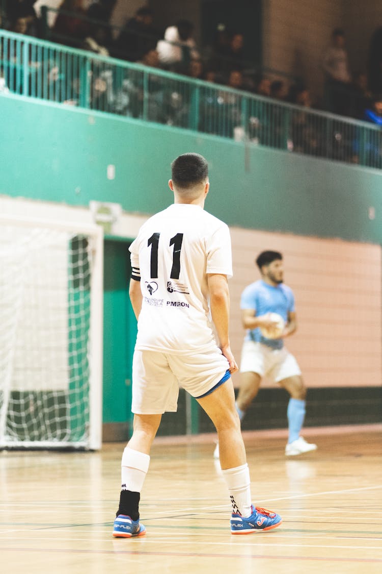 Men Playing Football On A School Gymnasium 