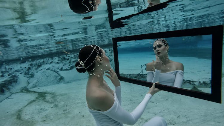 Woman Posing With Mirror Underwater