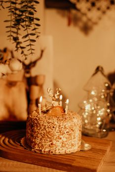 Close-up of a rustic almond cake with lit candles, perfect for festive celebrations.