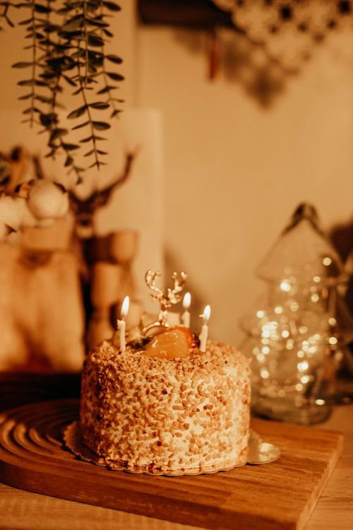 Free Close-up of a rustic almond cake with lit candles, perfect for festive celebrations. Stock Photo
