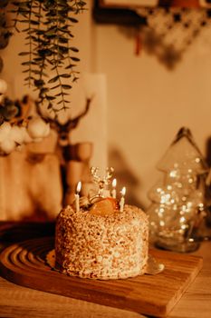A cozy scene of a festive cake with burning candles, perfect for birthdays or celebrations.