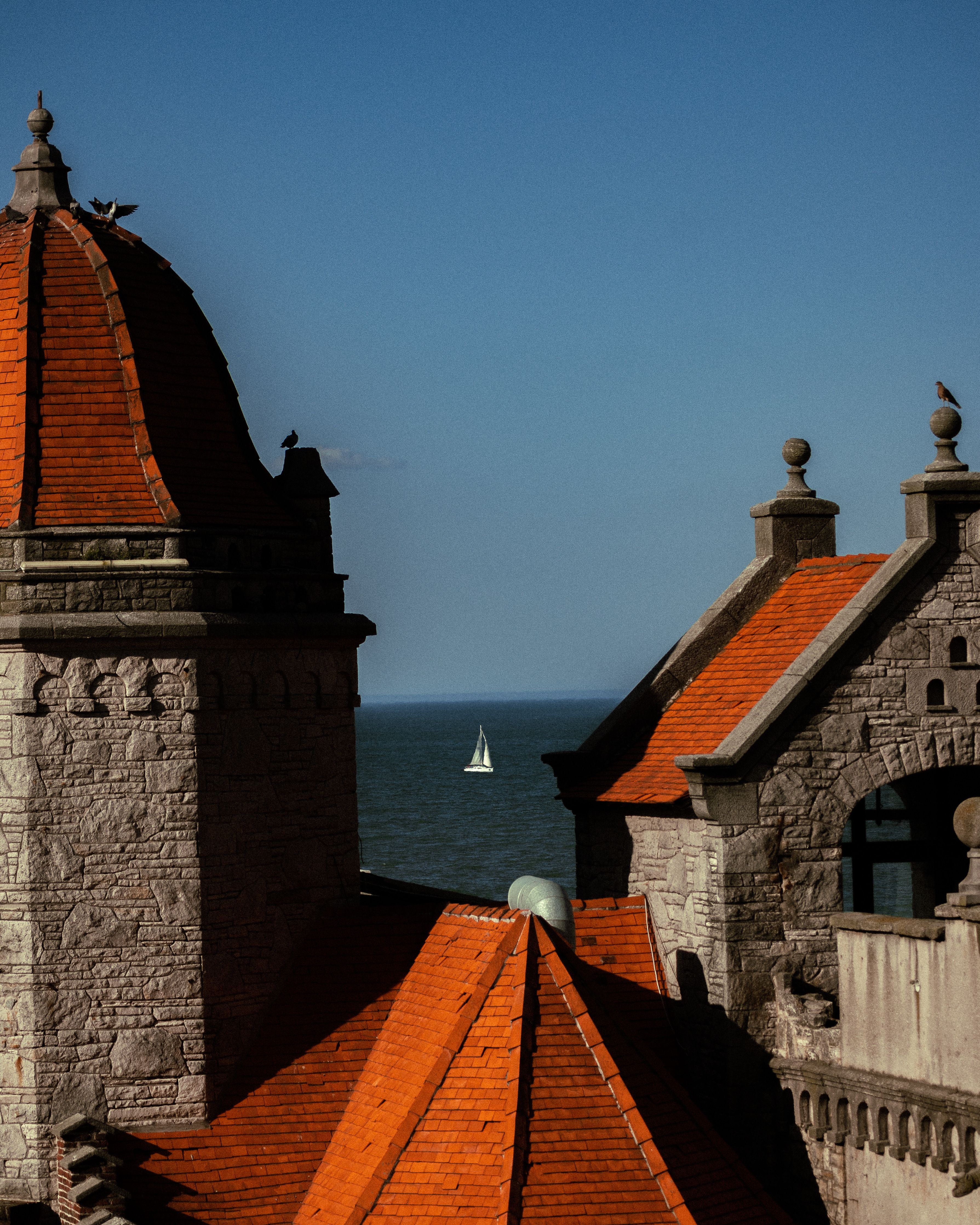 A peaceful sailboat viewed from historical rooftops in Mar del Plata, Argentina.