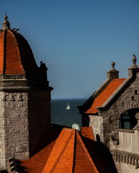 A peaceful sailboat viewed from historical rooftops in Mar del Plata, Argentina.
