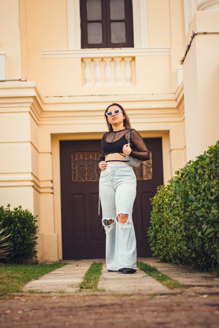 Woman In Casual Wear Standing Near House