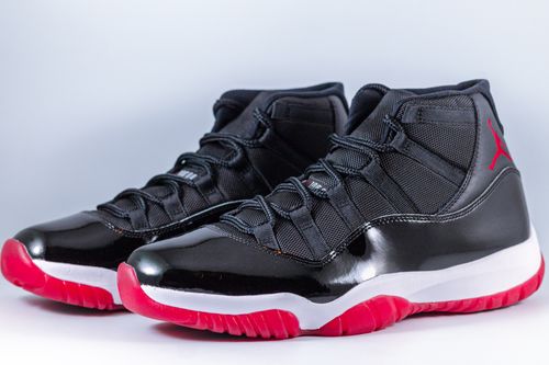 Free High-top black and red sneakers with a glossy finish, perfect for fashion and sports enthusiasts. Stock Photo