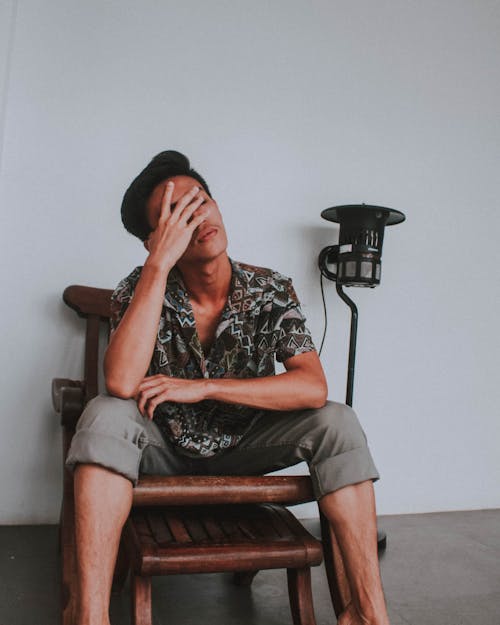 Free Man Sitting on Wooden Chair Stock Photo