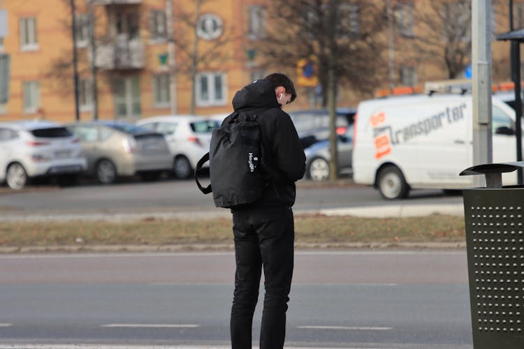 Man Standing On Bus Stop