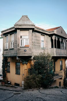 Charming vintage wooden house with intricate facade on a picturesque cobblestone street.