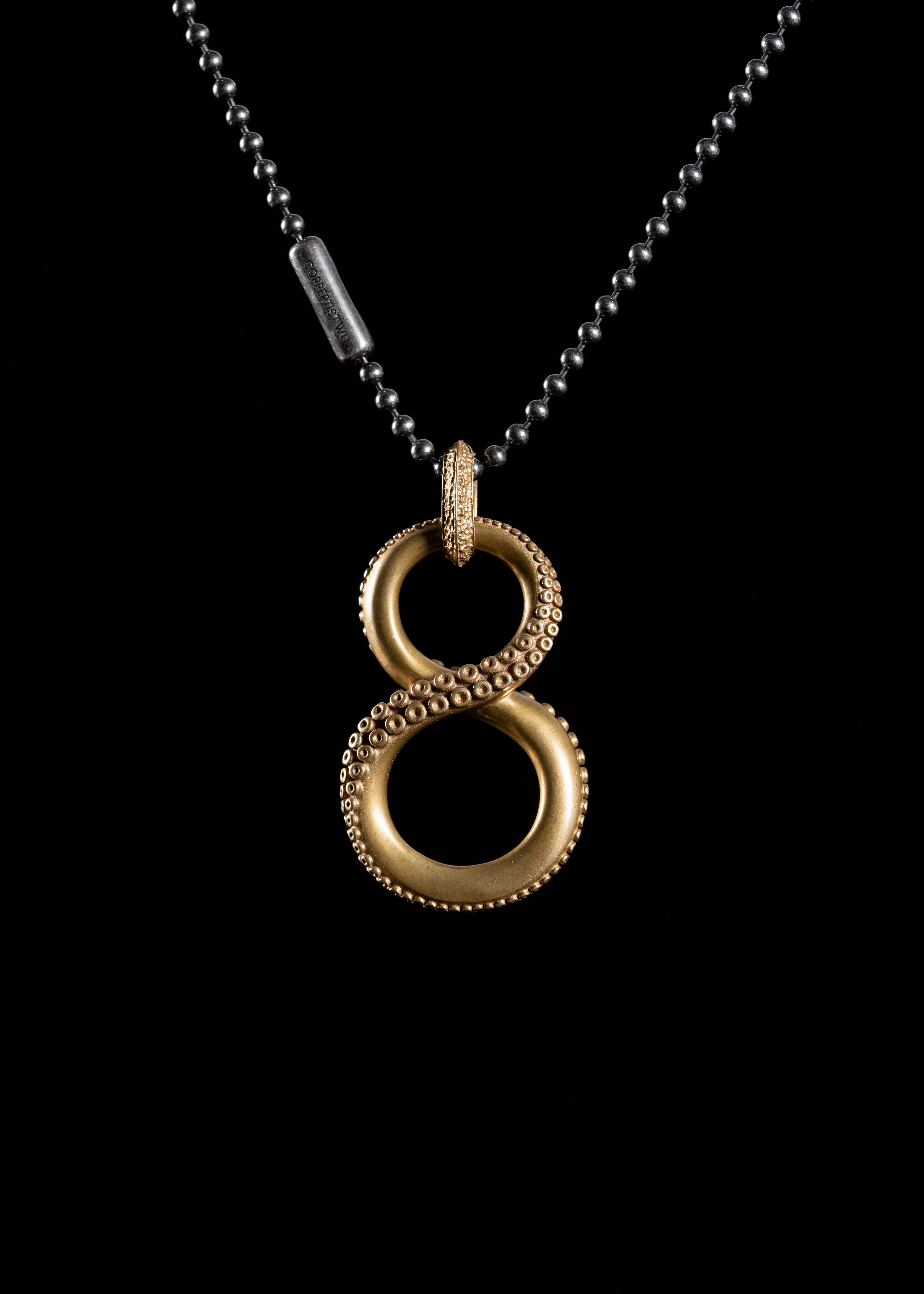 Brass Octopus Infinity Pendant on Bead Necklace · Free Stock Photo