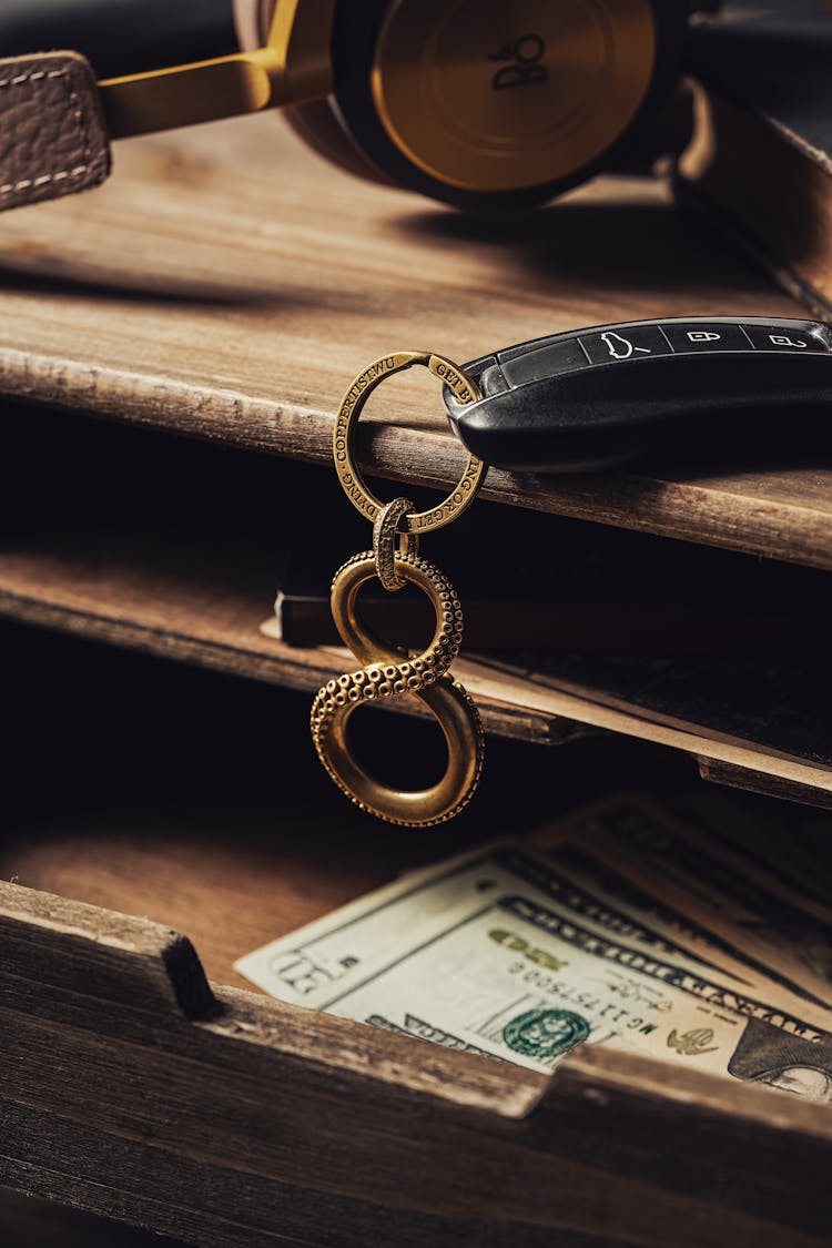 Key Ring With A Car Remote Control Lying On A Wooden Drawer