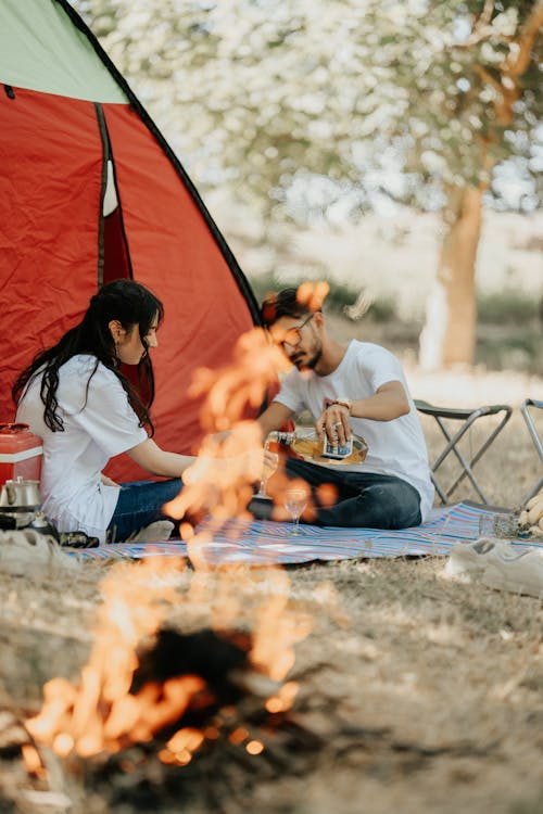 Couple Camping with Bonfire at Park