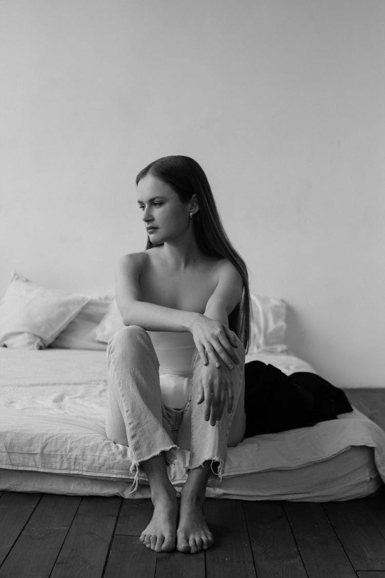 Pretty Brunette Sitting On A Mattress