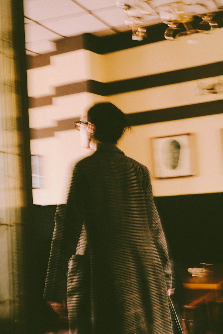 Back Of A Man In A Coat And Eyeglasses Walking