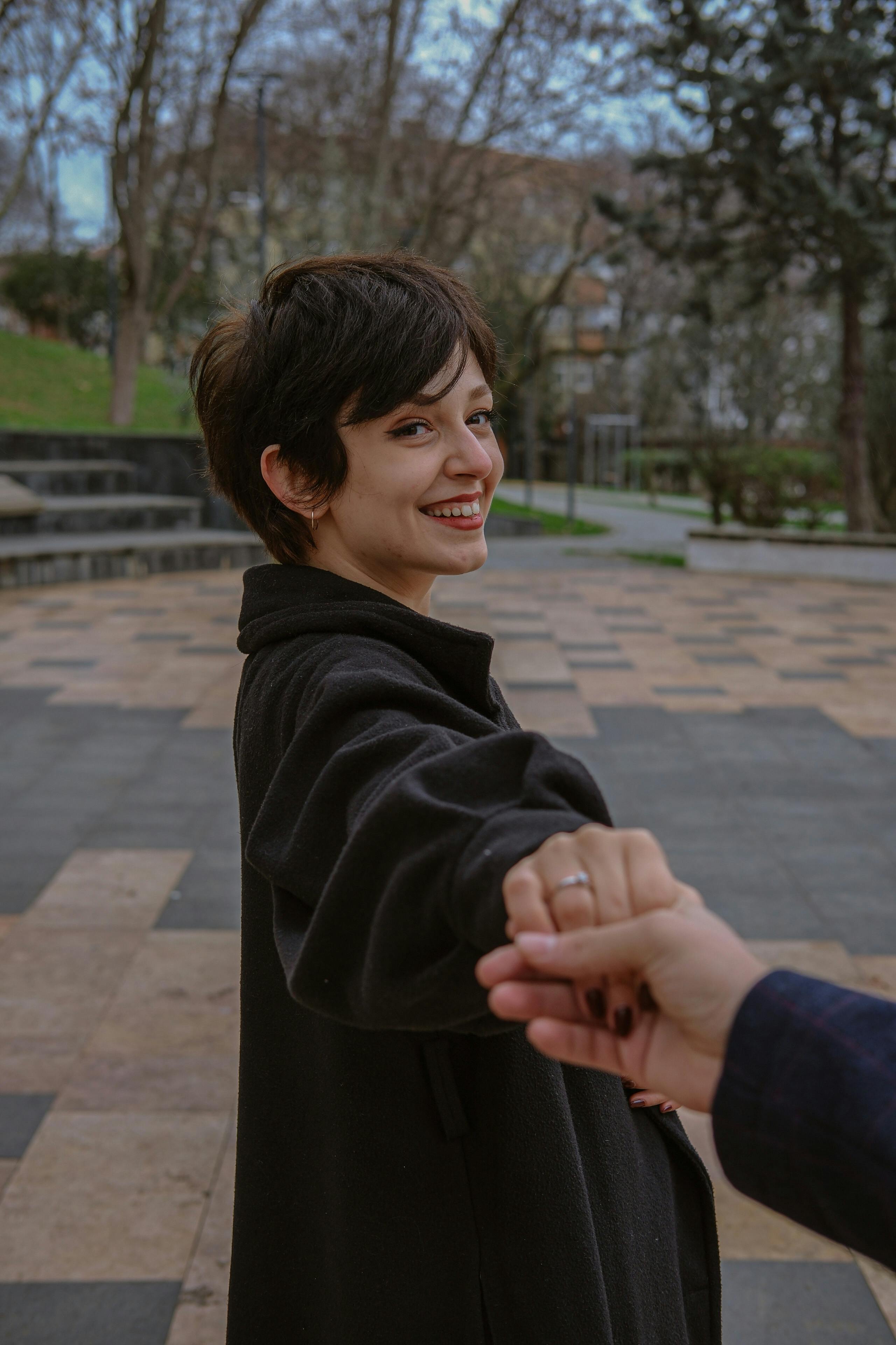 a woman holding out her hand to a man