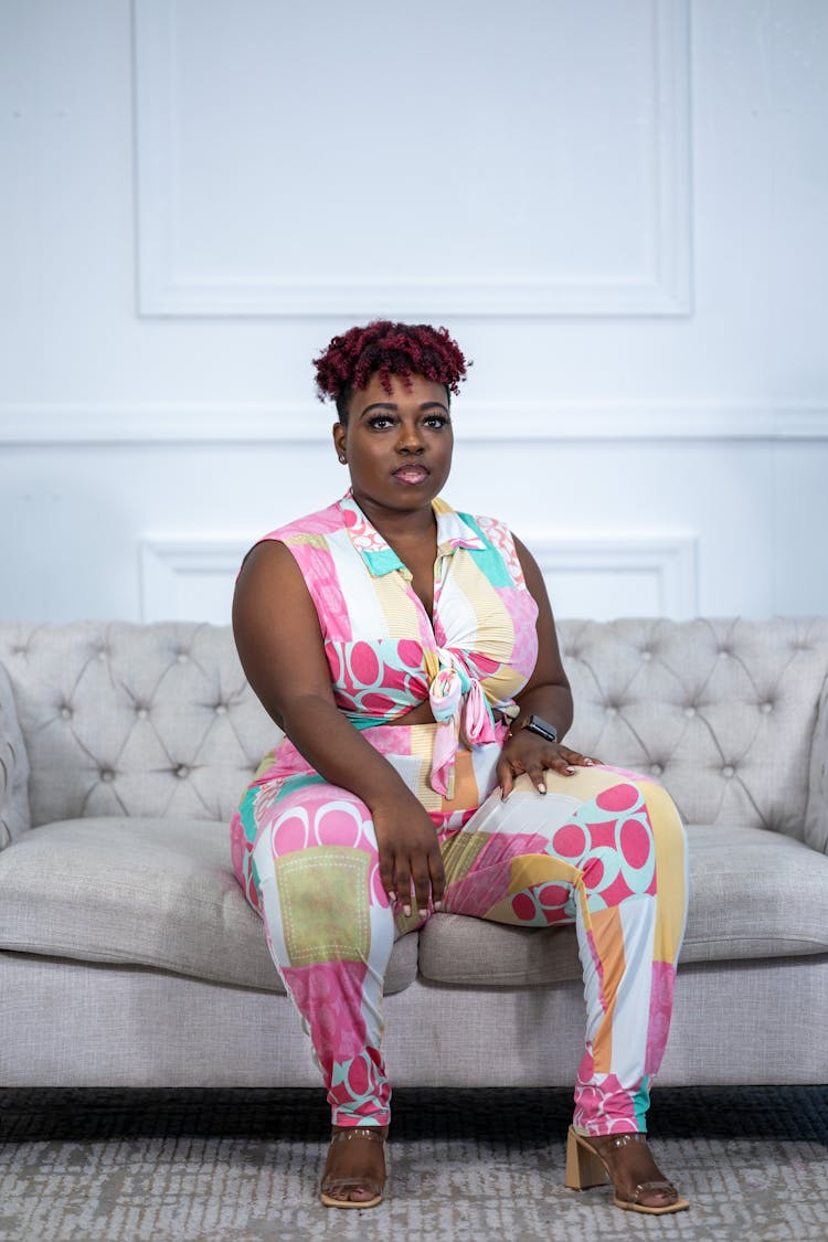 Stylish Overweight Woman Sitting On Sofa