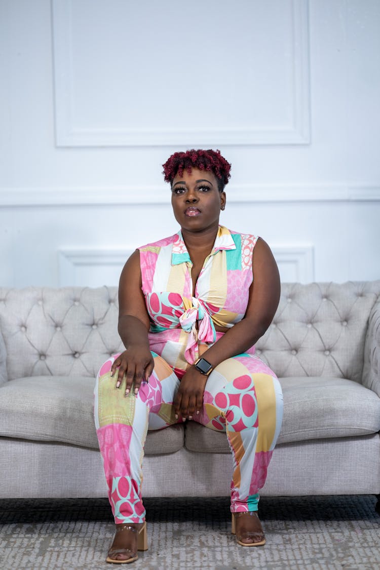 Overweight Woman In Costume Sitting On Couch