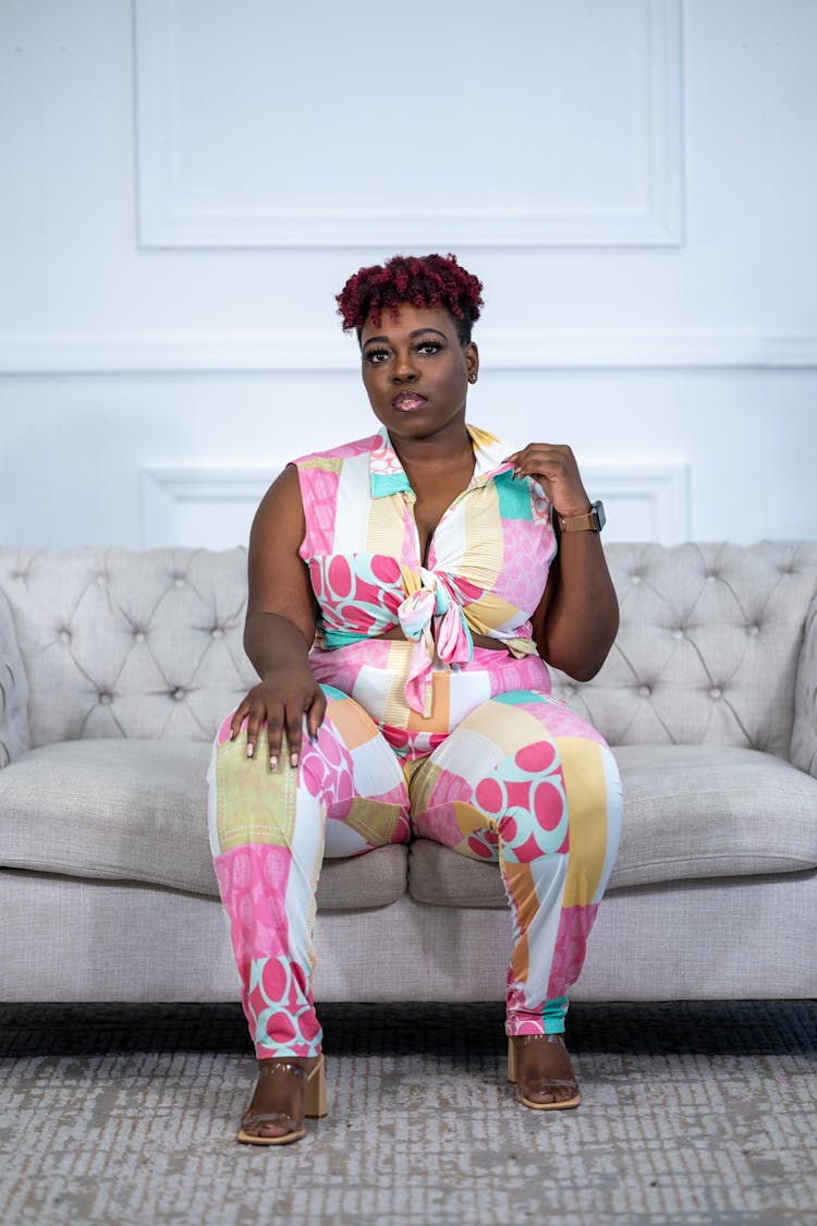 Overweight Woman In Stylish Costume Sitting On Couch