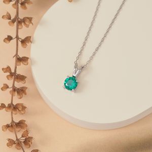 Silver pendant necklace on a pale stand, photo by Arif khan on Pexels