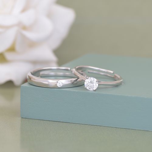 Free Close-up of two silver rings with diamonds on a green surface, perfect for engagement or wedding themes. Stock Photo