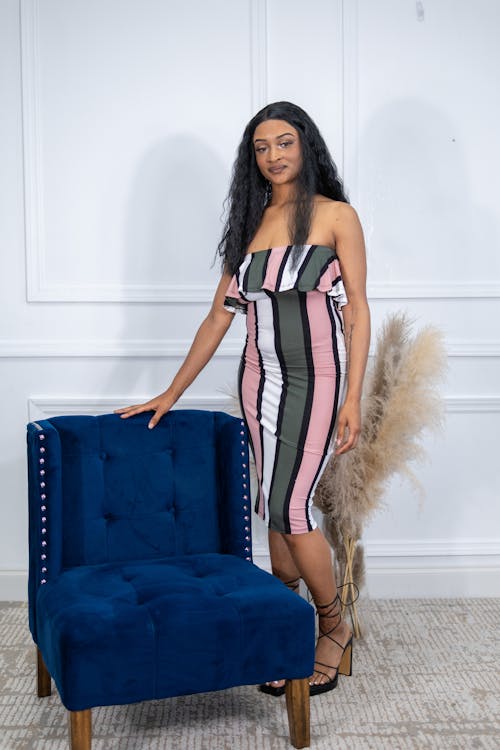 Young Woman in a Dress and High Heels Posing in Studio 