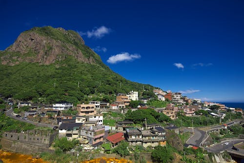 Assorted-color Concrete Buildings Near Mountain